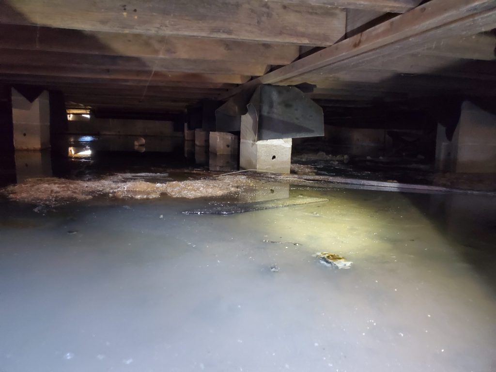 Standing water in a flooded crawl space after a Indianapolis storm