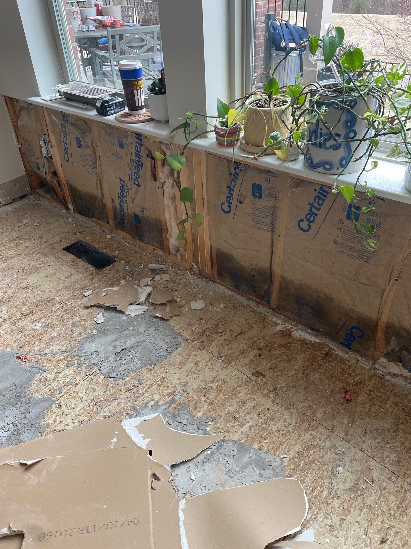 Damaged wall insulation and subfloor after storm damage in Indianapolis